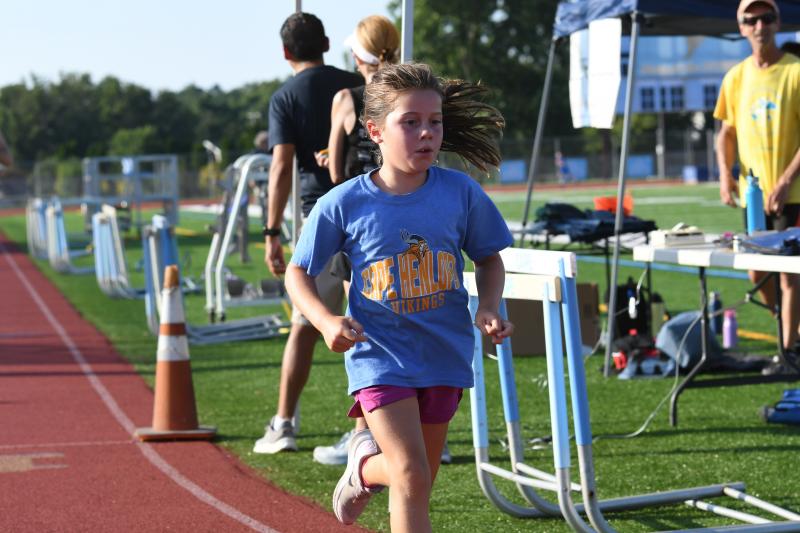 Ruby Epps, on her last day of being 7, competes in seven events at the Tuesday night track meet.
