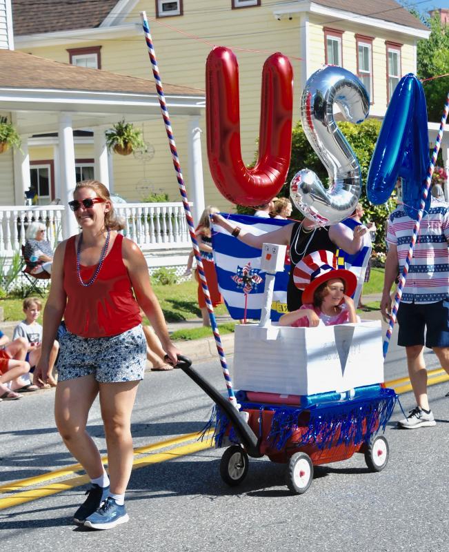 Mary Quirion pulls Brady in a USA wagon during the annual Doo-Dah Parade.