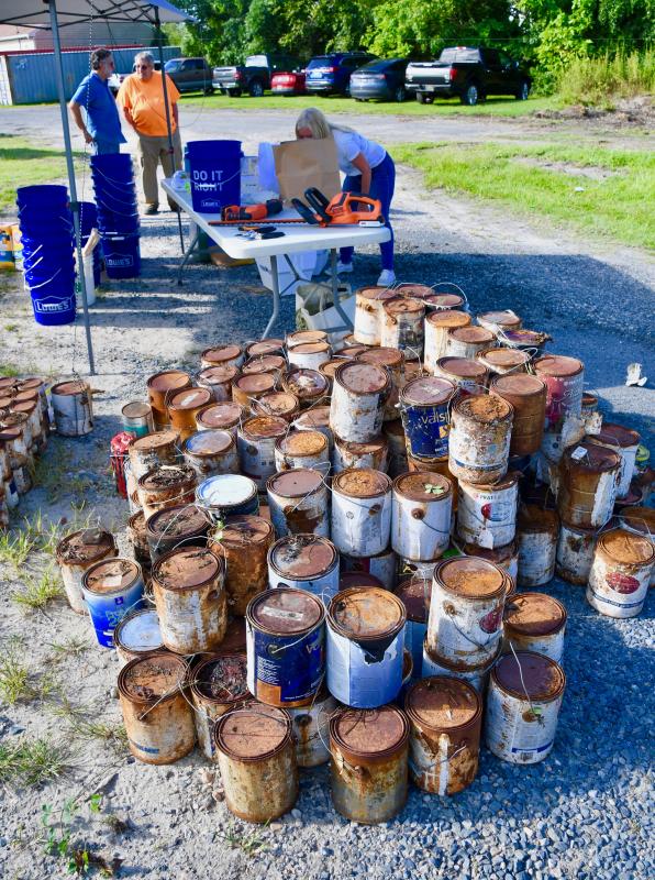 Hundreds of old paint cans were stored on the property destined to be a Pallet shelter village.