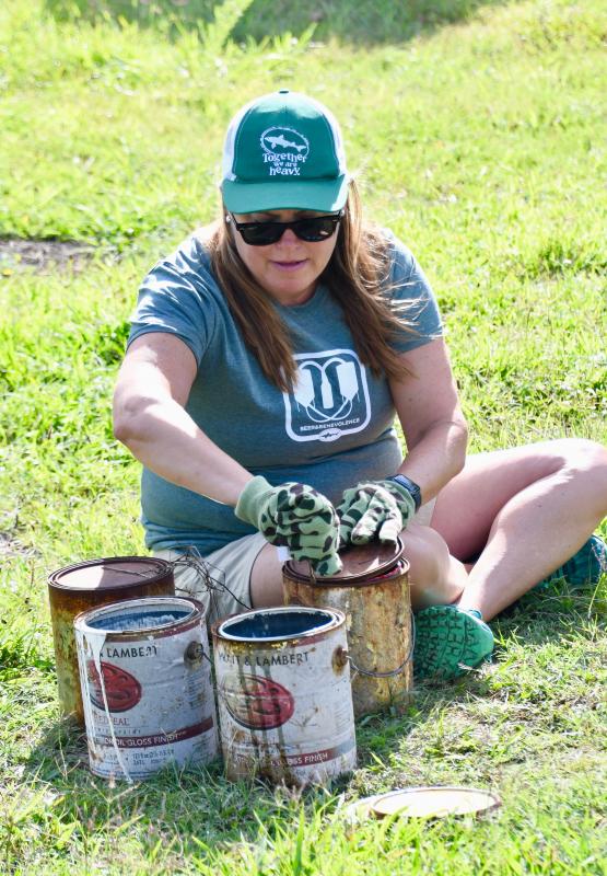 Mariah Calagione prepares old paint cans for disposal.