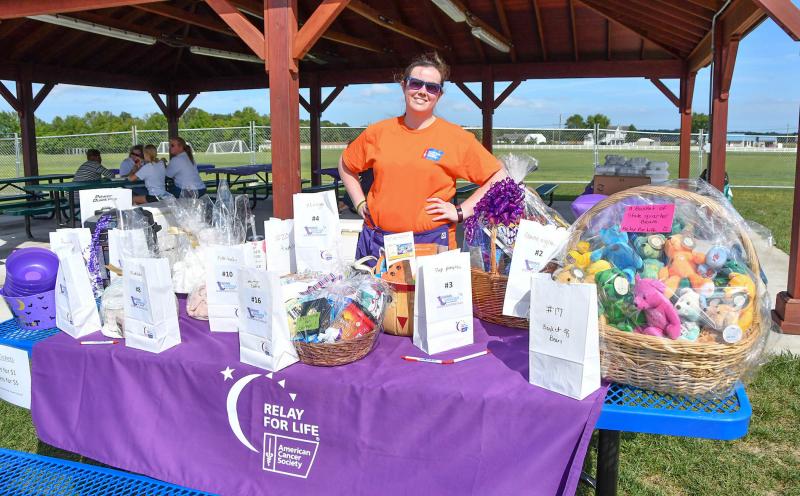 Silent auction chair Shelly Laubden displays the items up for bid.
