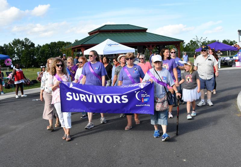Cancer survivors walk the lead lap of Relay for Life.