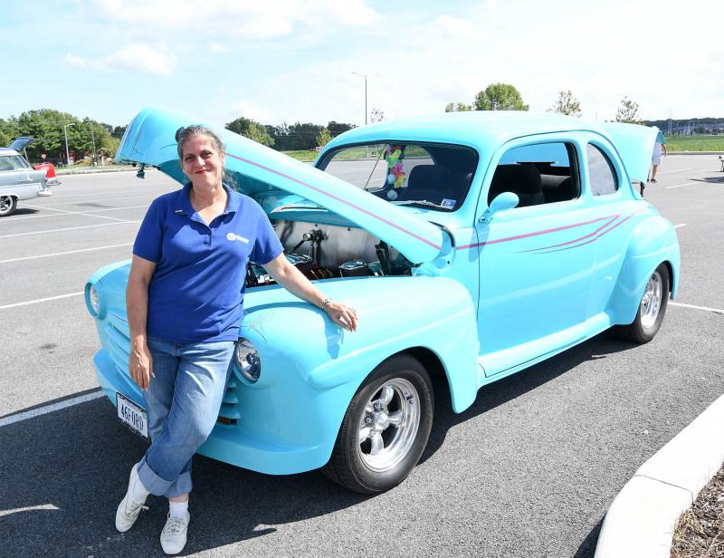 Christine Johnson stands with her 1946 Ford during the car show.