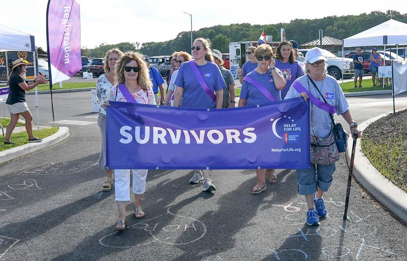 Cancer survivors walk the lead lap of Relay for Life.
