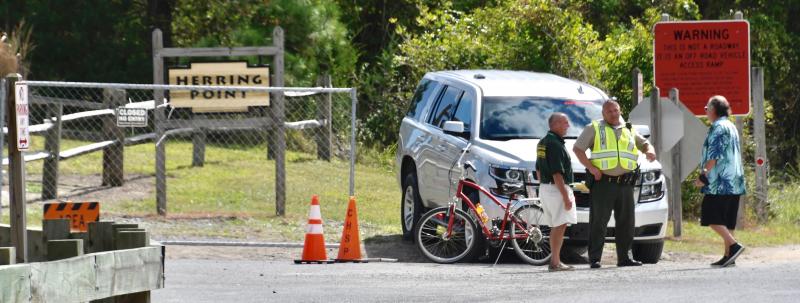 A Delaware State Parks ranger is parked at the entrance to the parking lot.
