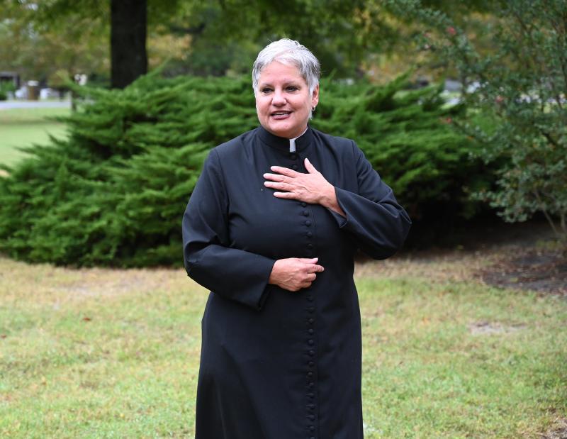The Rev. Shelley D. McDade welcomes the collection of dogs, cats and their owners to the animal blessing ceremony.