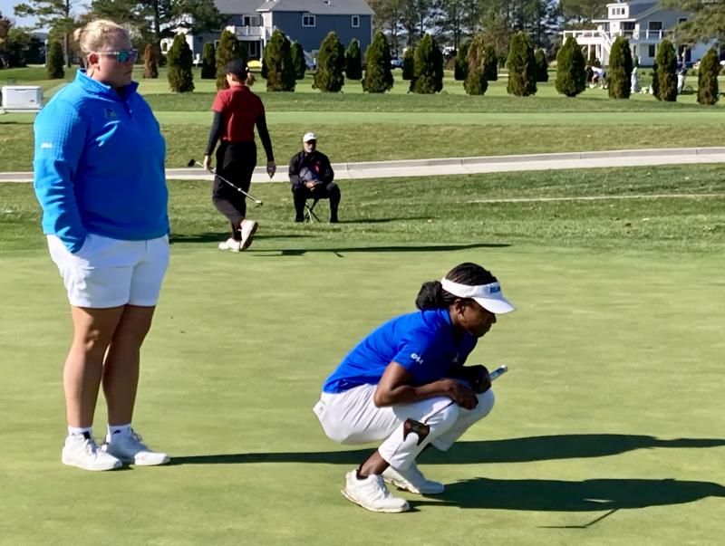 University of Delaware assistant coach Jackie Mullens, left, observes Blue Hens golfer Christina Carroll lining up a putt on the ninth green at Rehoboth Beach Country Club during the opening round of the ninth annual Blue Hen Invitational Oct. 15. Carroll eventually finished T-8 in the 54-hole tournament. FRITZ SCHRANCK PHOTO
