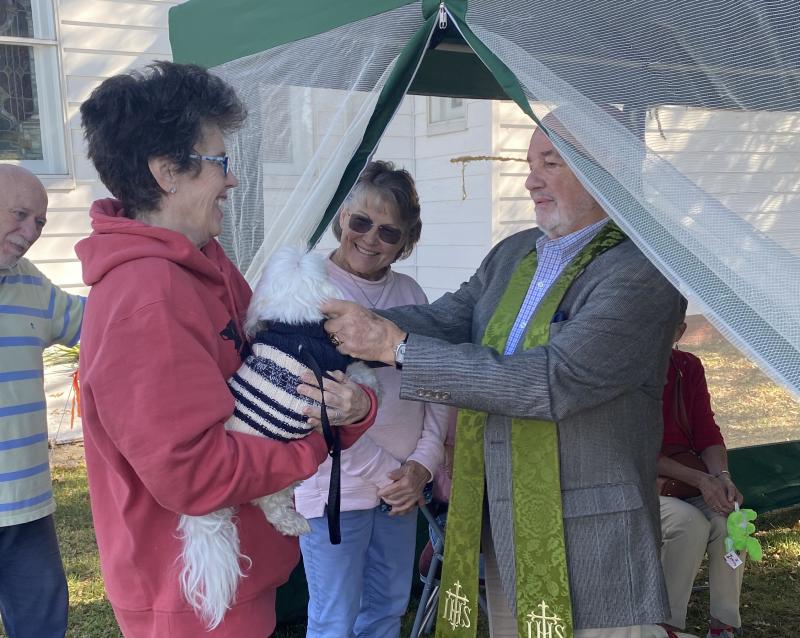 The Rev. Dr. S. Willard Crossan III says a prayer for Georgie during Groome Church’s Blessing of the Animals event Oct. 15 in Lewes. MEGAN SMITH PHOTOS
