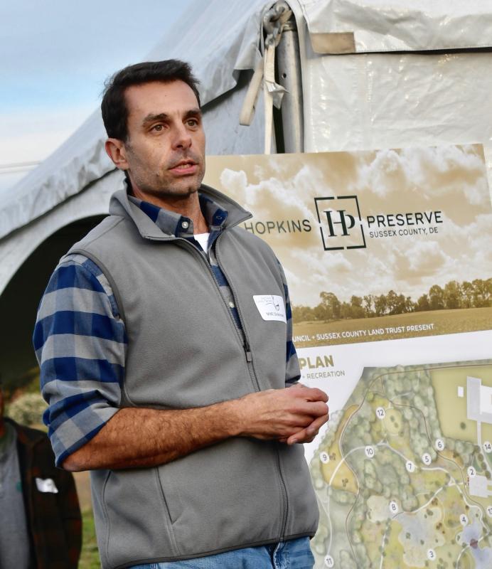Land trust board member Mike Dickinson welcomes the large crowd to the unveiling event.