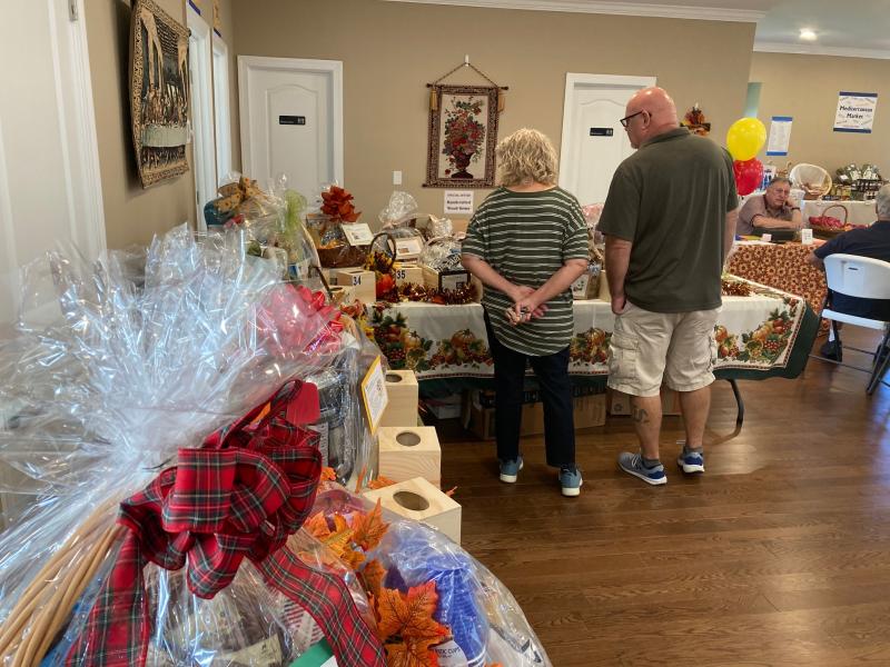 Visitors to the Fall Fest peruse the 39 gift baskets available during the church’s silent auction.