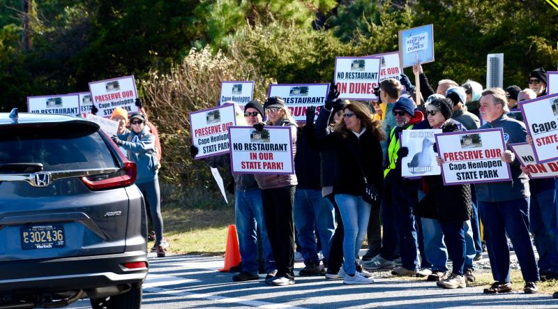 Protesters in the Nov. 13 March to Preserve Our Park wave their signs to cars on Cape Henlopen Drive in opposition to the proposed Cape Henlopen State Park restaurant.