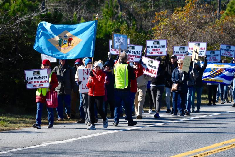 Some of the nearly 250 marchers carry their protest signs along Cape Henlopen Drive.