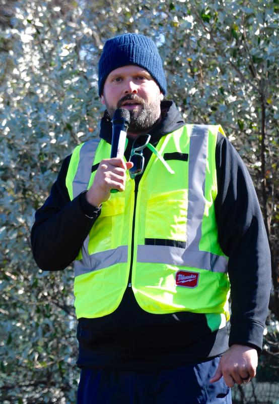 Kevin Lynam, a wildlife photographer and advocate, tells those taking part in the march that the park must be kept in its natural state and that a restaurant would forever change the landscape.