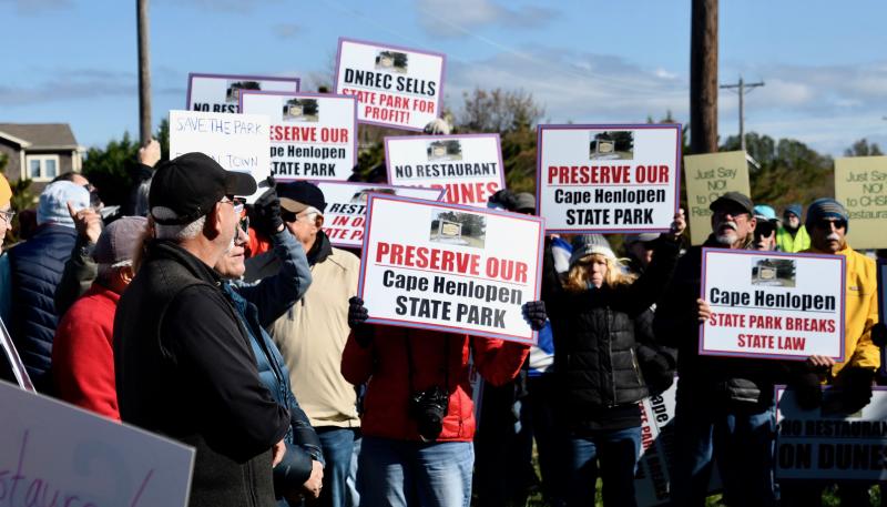 Marchers gather near the entrance to Cape Henlopen State Park after walking down Cape Henlopen Drive.