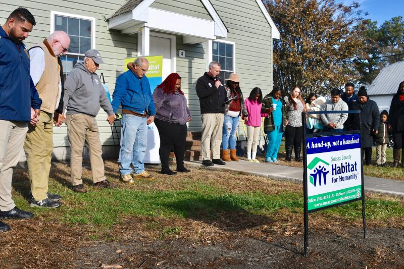 Sussex County Habitat for Humanity CEO Kevin Gilmore, center, offers a blessing during a Nov. 29 ceremony for the upcoming Kimmeytown Revitalization Project in downtown Georgetown. RON MACARTHUR PHOTOS