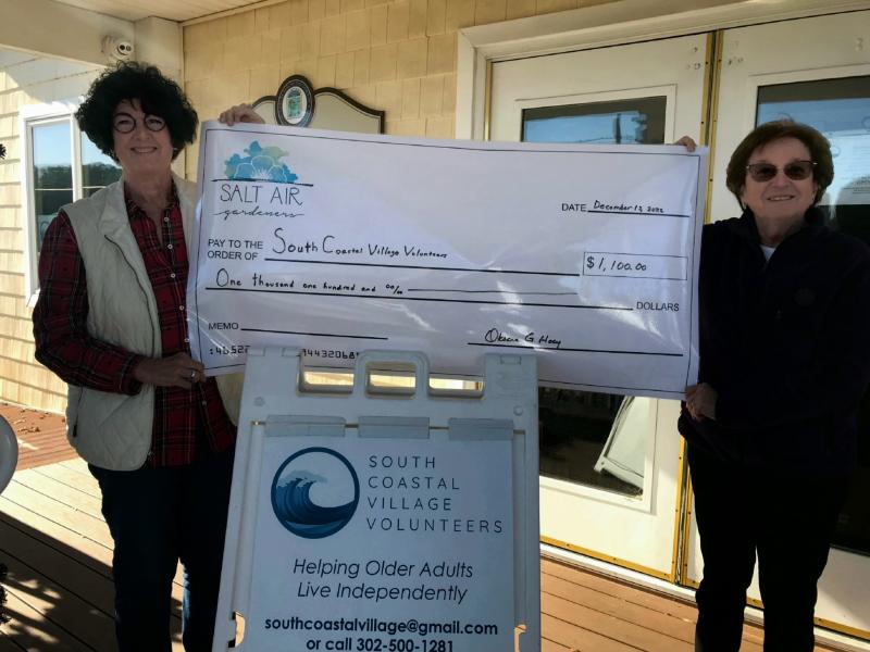 South Coastal Village Volunteers Head of Development Kathy Green, left, accepts a donation check from Oksana Hoey, Salt Air Gardeners president. SUBMITTED PHOTO