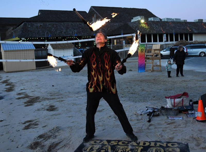 Carlos Mir aka Cascading Carlos gives an exciting fire-juggling performance to entertain the crowd.