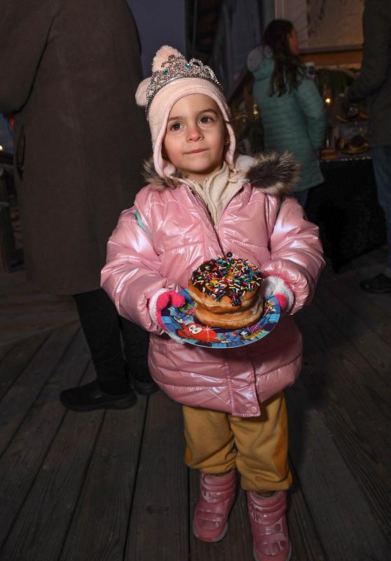 Rose Honan, 3, can’t decide which sweet treat to enjoy first.