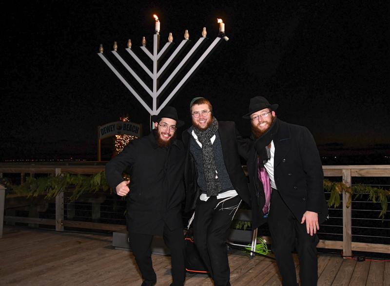 Dancing around the menorah are (l-r) Rabbi Mendel Deitch,
Rabbi Sholom Vogel from Chabad of Southern Delaware and Rabbi Yerucham Engel.