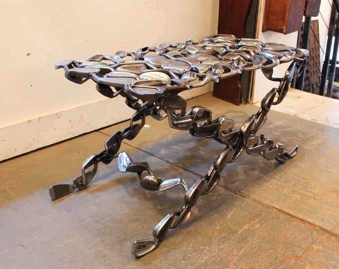 Looks like someone had a spot welder and too much time on their hands in making this table out of retired golf club and putter heads. SOURCE: ETSY