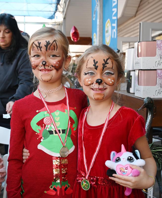 Fresh off their face-painting fun are Emma Zierty, 7, left, and Emma Berry, 7.