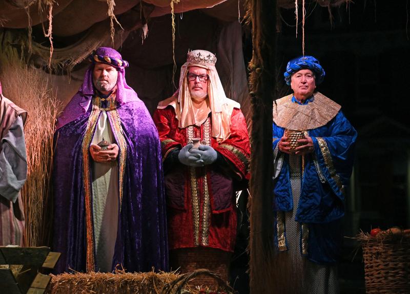 Three wise men offer gifts to newborn baby Jesus.