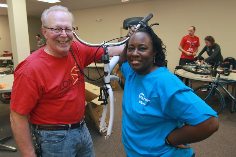 Volunteering at the Free Bikes 4 Kidz Delaware kickoff event hosted by Bayhealth are local cyclist Tom Bahnsen, left, and Calasha Wisher, Delaware State University executive assistant to the athletic director. SUBMITTED PHOTO
