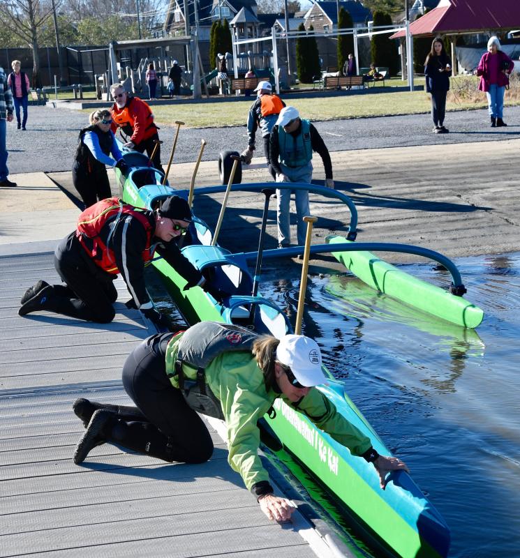 Club members place their canoe along the dock-launch in Canalfront Park as they prepare for a 10-mile paddle Dec. 30.