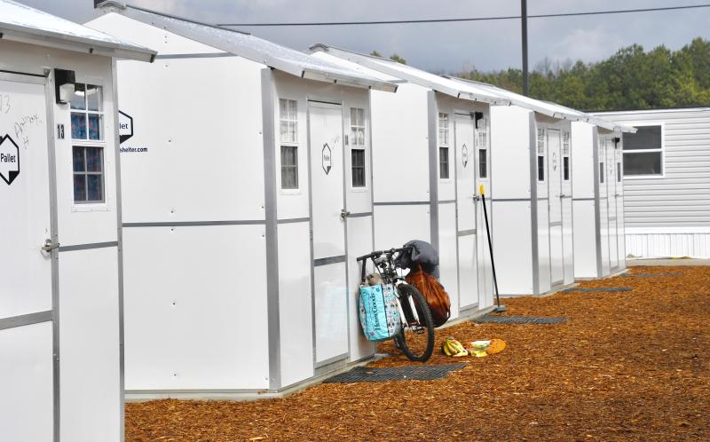 One of the Springboard Collaborative Pallet Village residents has his bicycle parked outside his cabin as the community begins operation the first week of February. RON MACARTHUR PHOTOS