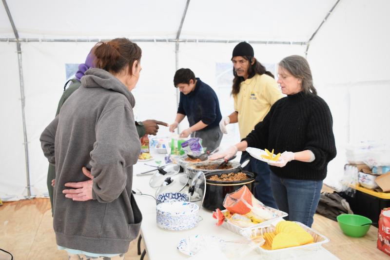 A lunch of tacos is served by (l-r) Jaime Delacruz, Eric Standifer and Carolyn Berl, food manager.