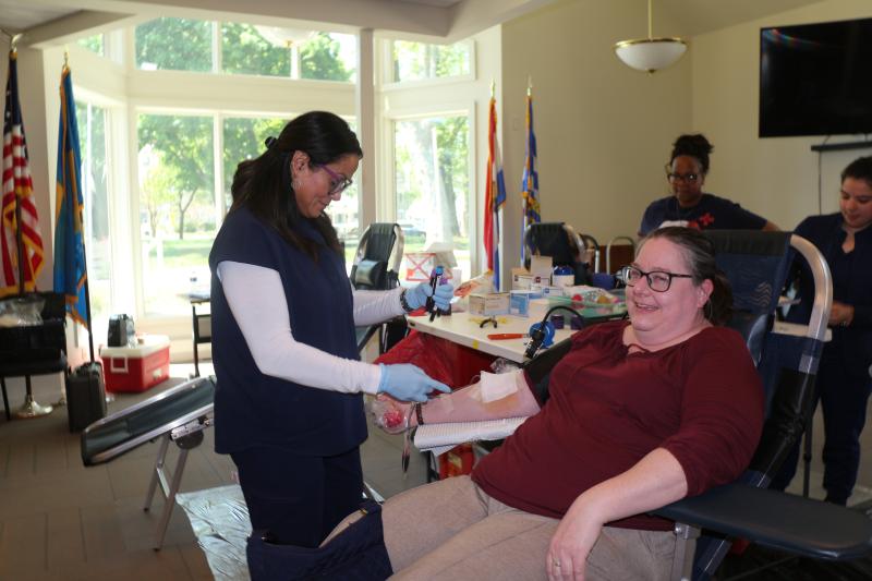 Madeline Hernandez collects blood from Lewes City Planner Janelle Cornwell.