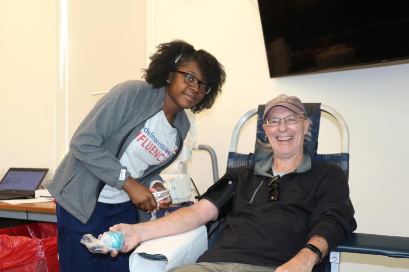 Adrian Haughton prepares Kevin Murphy to donate. He and his wife, Pam Costanzi, were happy to bleed for their city.