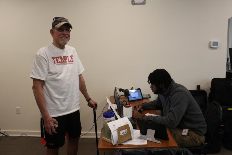 Is he an owl or is he a fox? John Delpino sports a Temple Fox School of Business shirt because he does give a hoot about donating blood. Jordan Singletary, right, prepares his paperwork.