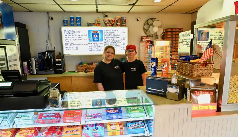 Running the Clayton’s concession stand are Leah Mitchell, left, of Dagsboro and Gavin Grove of Ocean View. What would a movie be without popcorn and other treats? RON MACARTHUR PHOTO