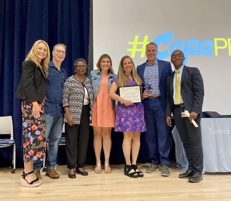 Gathered are Assistant Superintendent Jenny Nauman, board member Jason Bradley, board member Janet Maull-Martin, board member Jessica Tyndall, Peacock, Superintendent Bob Fulton and 2023 Cape Teacher of the Year Rony Flechier. ELLEN DRISCOLL PHOTO