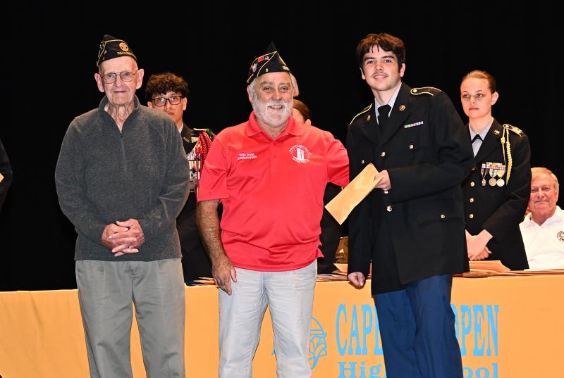 American Legion Post 5’s Tom Dahl and Pat Richardson present an award to Andrew Henion.