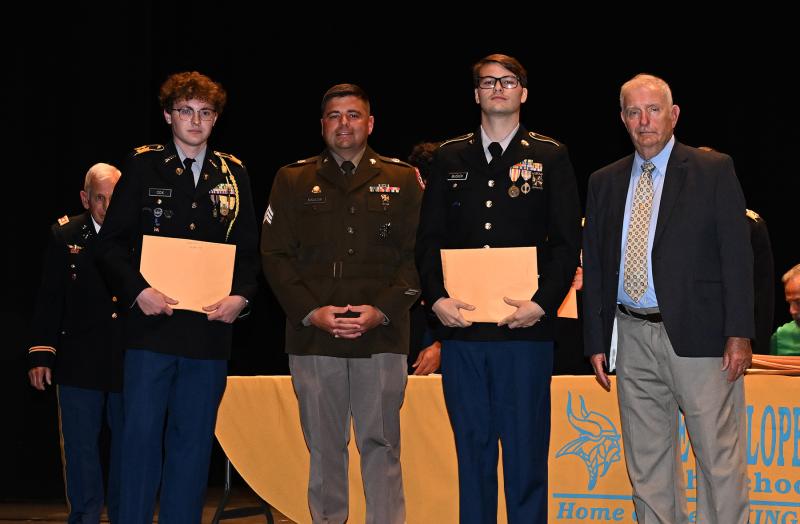 Adain Cox, left, and William Busick are presented the Association of the Army Medal from Sgt. Maudlin and Sgt. Maj. William Blakley.