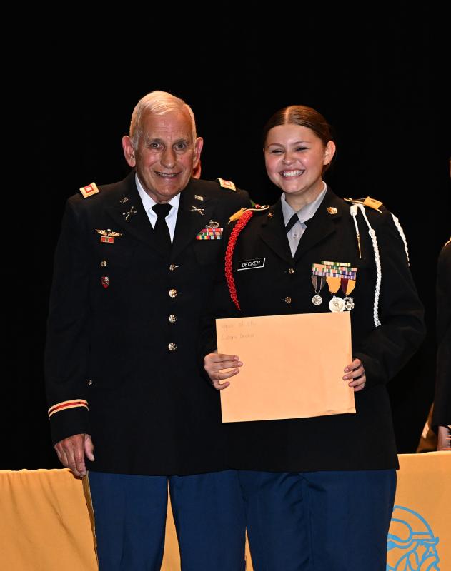 Jenna Deker receives the Veterans of Foreign Wars Post 6984 Medal from JROTC senior Army instructor Lt. Col. Ronald Erale.