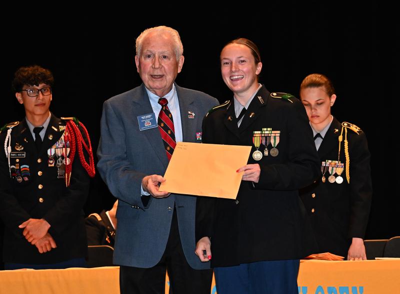 Col. Gene Herbert of Reserve Officers Association presents the ROA Medal to Cadet Montana Jones.