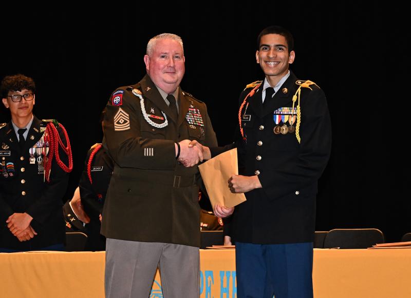 Emmanuel Majjul receives the Retired Enlisted Association Medal from Cape’s First Sgt. Philip Webb.