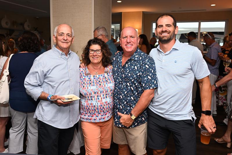 Enjoying the happy hour are (l-r) Jeff Fried, Emilie Paternoster, Tom Protack and Jeff Brown.