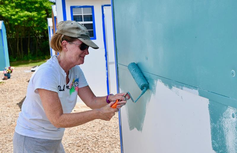 Kim Hoey Stevenson of Lewes takes a turn at a roller during the first day of painting.