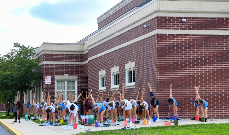 Hiba Stancofski leads field hockey players through stretching and relaxation. DAVE FREDERICK PHOTO