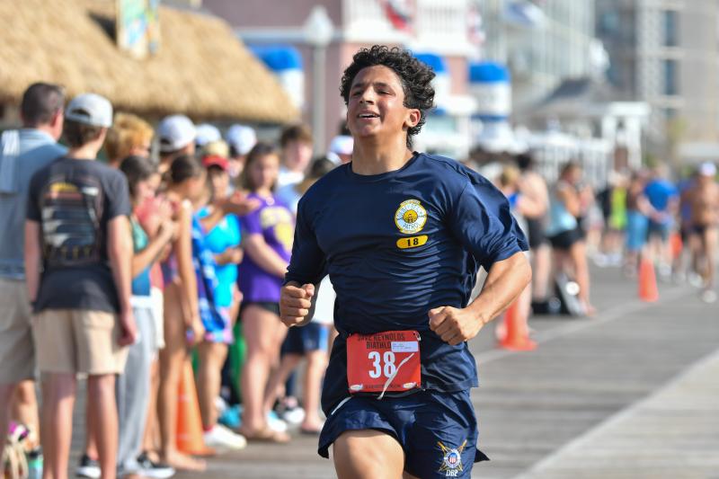 Luca Miller, 17, crosses the finish line in 38:34.