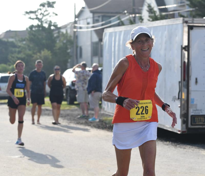 Debbie Isser, competing in the Race for the Paws 65-69 age group, ran 23:34 to set a new course record. DAVE FREDERICK PHOTOS