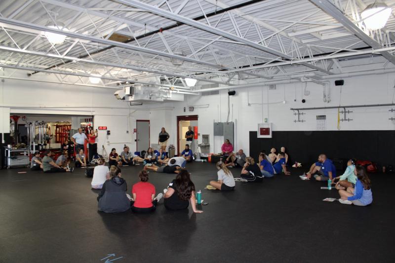 Sports Medicine Emergency Management co-owner Ed Strapp shows high school athletic trainers how to begin caring for an athlete.