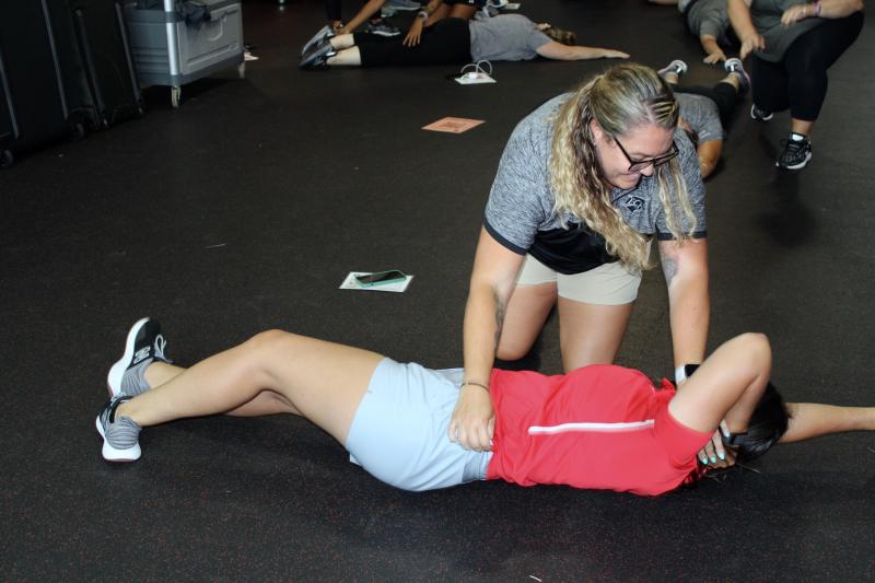 Sussex Tech athletic trainer Heather Heidel performs a drill that allows someone delivering care to safely move a patient to a position of care. Delaware Athletic Trainer’s Association President Kathleen Kenney is the one in Laurel red.