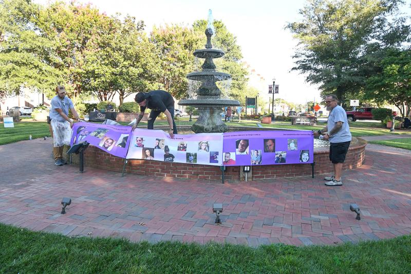 Getting ready to install the banner to commemorate the loved ones lost to overdose are (l-r) Jake Fox, Jonny McDaniels and William Moorehead.