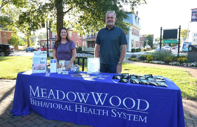Judy Schlott and John Corrigan of Meadow Wood Behavioral Health give out information.