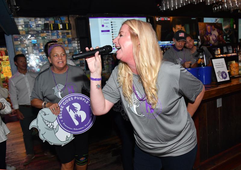 Ashley Foster sings for the crowd as Amanda Neal looks on.